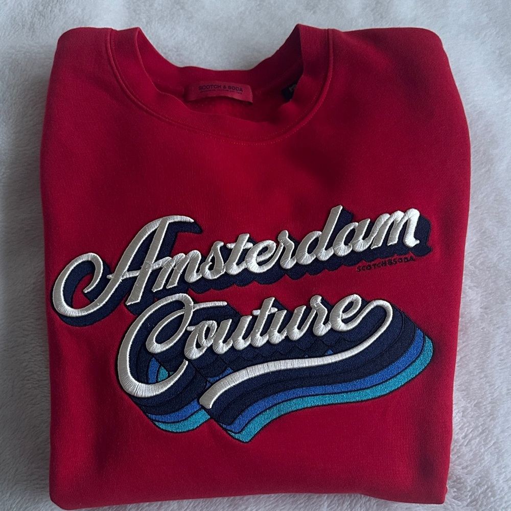 Scotch & Soda Red Crewneck Sweater with white lettering and blue wavy lines.